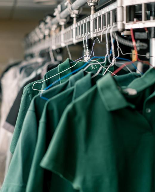 industrial laundry in the hotel clean shirts of employees and guests sorted after washing hang on clotheslines concept of cleanliness and hospitality industrial laundry in the hotel clean shirts of employees and guests sorted after washing hang on clotheslines concept cleanliness and hospitality